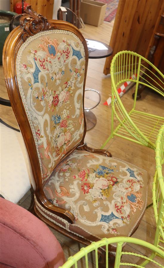 A Victorian walnut spoon back nursing chair with tapestry upholstery